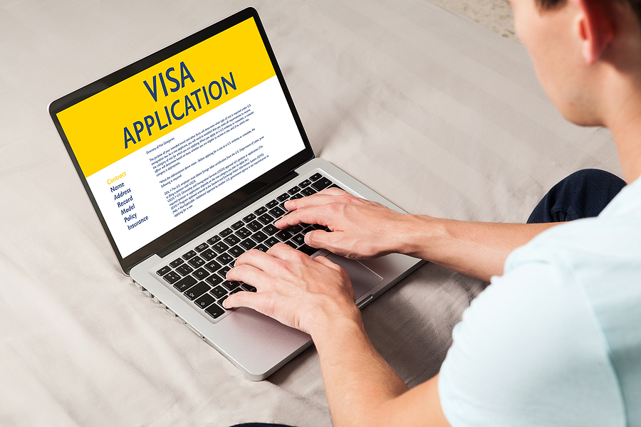 Man doing electronic Visa Application in a laptop by internet.