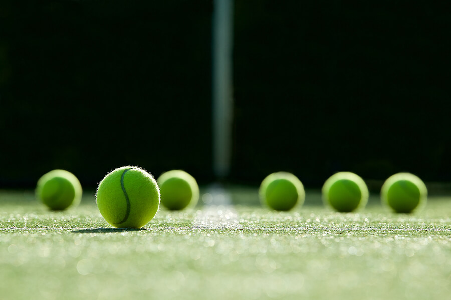 Soft Focus Of Tennis Ball On Tennis Grass Court